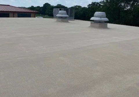 Flat roof with two white rooftop vents